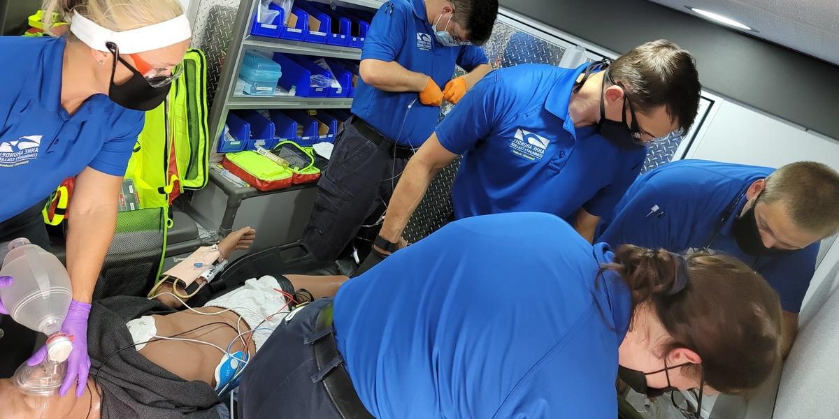 EMT students inside ambulance.