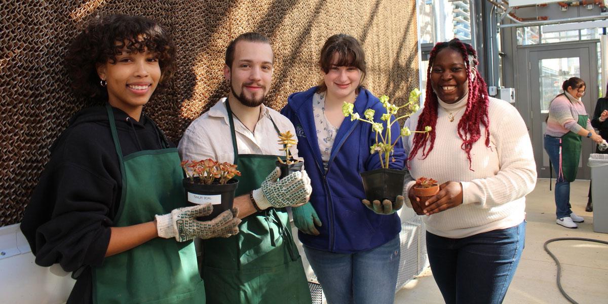 Students posing with plants.