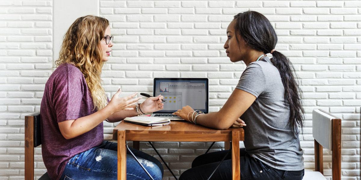 Two students helping one another.